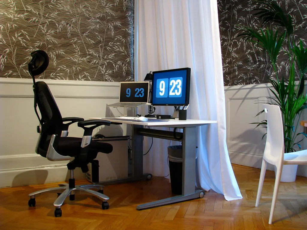 Desk workspace with monitor and ergonomic office chair